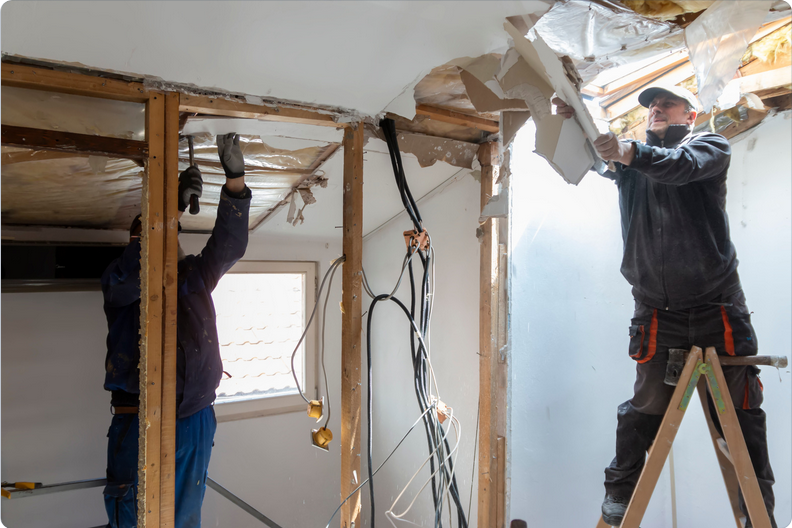 Drywall contractor removing water damaged drywall during repair process in Aurora Colorado Water damaged drywall being removed by Aurora Colorado drywall contractor